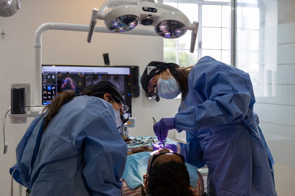 Two dentists working on a patient.